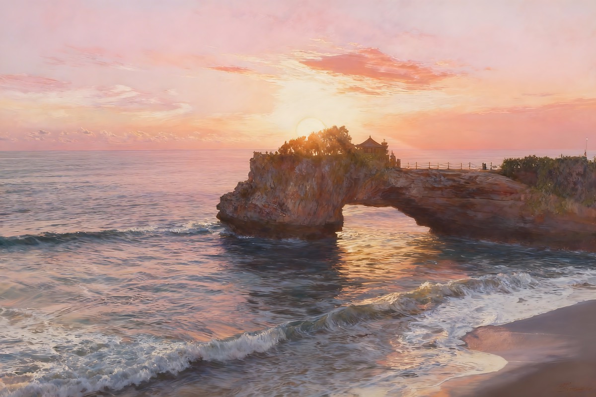 Golden coastal sunset beside a tree-covered cliff